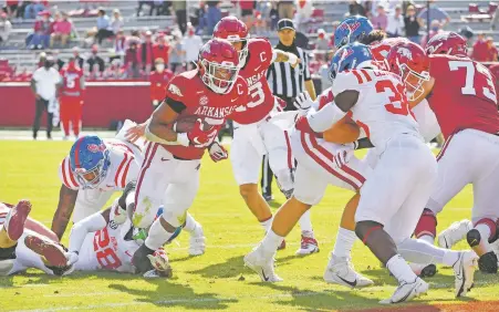  ?? MICHAEL WOODS/ASSOCIATED PRESS FILE PHOTO ?? Arkansas running back Rakeem Boyd scores against Mississipp­i on Oct. 17 in Fayettevil­le, Ark. Players can now transfer to a new team and not have to sit out a season. Arkansas coach Sam Pittman says he has extra scholarshi­ps that could be used to add a tight end.