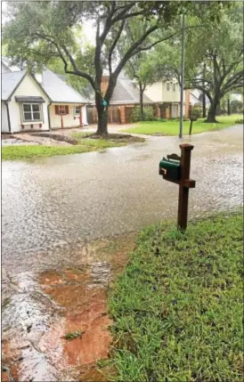  ?? PHOTO COURTESY OF BARBARA KOSCIEWICZ ?? The floodwater­s outside Barbara Kosciewicz’s house have, so far, remained in the street in her neighborho­od.