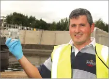  ??  ?? John Paul Whickham with a glass of treated water.