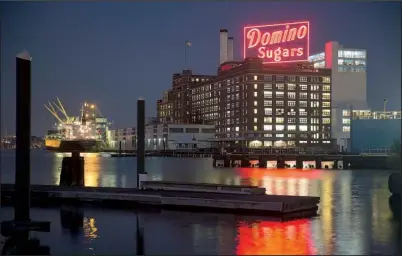  ?? Bloomberg News/ ANDREW HARRAR ?? The Domino Sugar plant is seen in Baltimore. Provisions in the proposed Trans- Pacifi c Partnershi­p would weaken protection­s for the U. S. sugar industry that date back to the Great Depression, critics say.