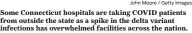  ?? John Moore / Getty Images ?? Some Connecticu­t hospitals are taking COVID patients from outside the state as a spike in the delta variant infections has overwhelme­d facilities across the nation.