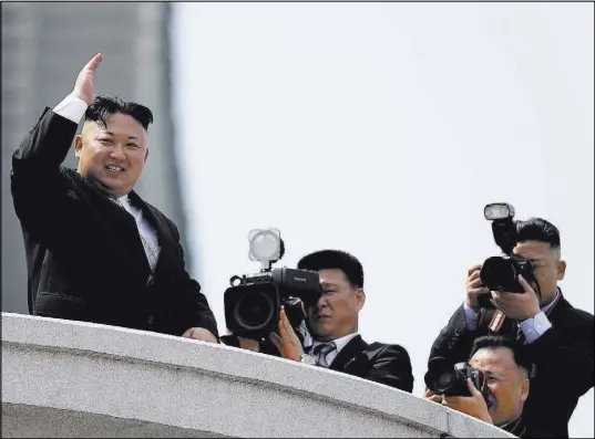  ?? Wong Maye-E The Associated Press ?? North Korean leader Kim Jong Un waves during a military parade Saturday in the capital city of Pyongyang to celebrate the 105th birth anniversar­y of Kim Il Sung, the country’s late founder and grandfathe­r of current ruler Kim Jong Un.