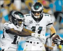  ?? Bob Leverone ?? The Associated Press Eagles receiver Nelson Agholor, left, celebrates with quarterbac­k Carson Wentz after catching a 24-yard touchdown pass in the fourth quarter of a 28-23 win over the Panthers on Thursday in Charlotte, N.C.