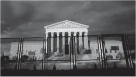  ?? STEFANI REYNOLDS/GETTY-AFP ?? Fences are seen in front of the U.S. Supreme Court Building.