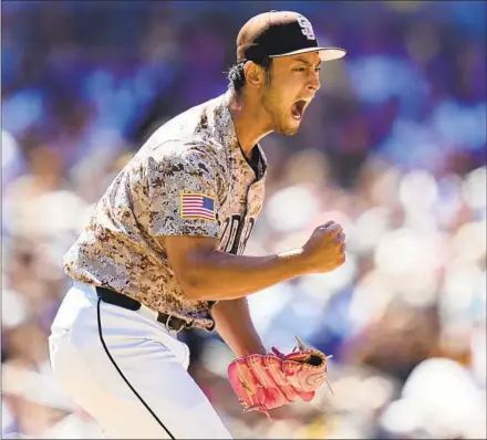  ?? Gregory Bull Associated Press ?? YU DARVISH reacts after getting the third out of the seventh inning to keep the Dodgers off the scoreboard Sunday. Darvish left the game after that inning, finishing with seven strikeouts and throwing 104 pitches to improve to 3-1 in 2024. The Padres won the game 4-0.