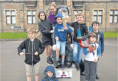  ??  ?? Youngsters looked after by the Spectrum charity enjoy a visit to the Harry Potter Oor Wullie statue that was in the grounds of Morgan Academy.