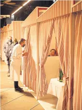  ??  ?? RIGHT
Chef Daniel Boulud greets customers inside sidewalk cabanas at Daniel in Manhattan.