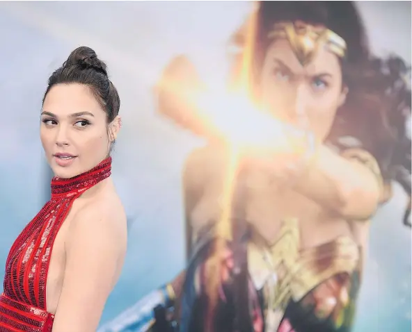  ?? — THE ASSOCIATED PRESS FILES ?? ‘I was bruised all the time, but nothing major. I had a mark here, a mark there,’ says Gal Gadot, who spent several months of intense training in sword play, martial arts combat, body sculpting and horseback riding to prepare for the role of Wonder...