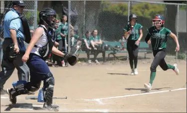  ?? PHOTOS BY BEA AHBECK/NEWS-SENTINEL ?? Above: Elliot Christian's Madi Sepp arrives at home plate to score a run during their game against Redwood Christian in Lodi on Saturday. Below: Elliot Christian's pitcher Anabelle Sepp pitches against Redwood Christian.