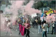  ?? ?? Protesters march with flares during a rally in Bayonne, southweste­rn France, Thursday, march 23. French unions are holding their first mass demonstrat­ions Thursday since President Emmanuel Macron enflamed public anger by forcing a higher retirement age through parliament without a vote. (AP)