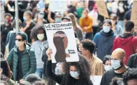  ??  ?? The protest started at Christie Pits Park and wound its way to Toronto police headquarte­rs on College Street.