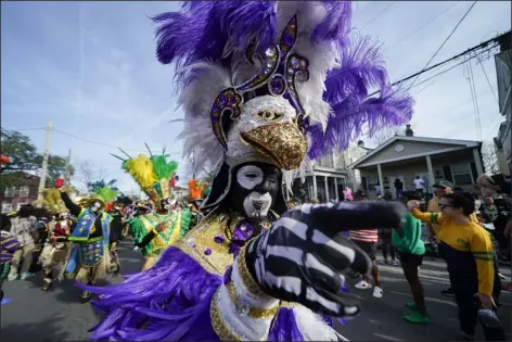  ?? GERALD HERBERT — THE ASSOCIATED PRESS ?? A member of the traditiona­l Mardi Gras group The Trams marches during the Krewe of Zulu Parade on Mardi Gras Day in New Orleans on Tuesday.