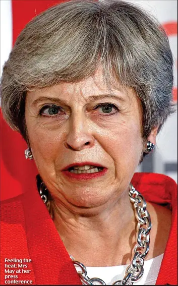 ??  ?? Feeling the heat: Mrs May at her press conference