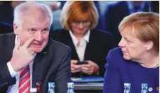  ??  ?? HANNIBACH HANSCHKE/REUTERS German Chancellor Angela Merkel (R) and Interior Minister Horst Seehofer take part in a conference about the equal living conditions between urban and rural areas in Berlin, Germany, on September 26, 2018.