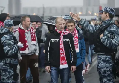  ??  ?? In this photo taken on Wednesday, April 18, 2018, police officers stop to check Spartak Moscow’s supporters before the a Russian Premier League Championsh­ip football match between Spartak Moscow and Tosno in Moscow, Russia. Photo: AP