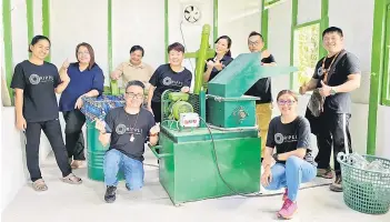  ?? ?? The Ripple Sabah and Carlsberg teams welcoming the new CarlsBot machine at Kampung Madsiang community hall in Penampang.