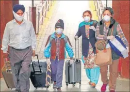  ?? PTI ?? Passengers with masks step out of the railway station in Jammu on Thursday.