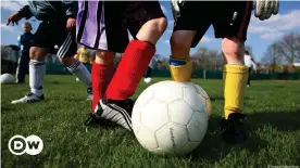  ??  ?? A scene you won't see during a lockdown: Children kicking around a ball together