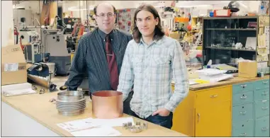  ?? Courtesy Riley Bran, University of Calgary ?? PHD candidate student Tim Friesen, right, and Robert Thompson, an associate professor and the head of the department of physics and astronomy at the University of Calgary, are creating an apparatus that traps anti-hydrogen particles for study.