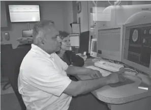  ?? Submitted photos ?? ABOVE: Khalid Malik, M.D., medical director of the Wadley Stroke Program, studies a CT scan of a patient’s brain with Sher Fomby, director of Cardiovasc­ular Service Line.