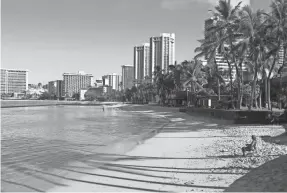  ?? CALEB JONES/AP ?? Waikiki Beach in Honolulu is nearly empty Oct. 2. After a summer marked by a surge of coronaviru­s cases in Hawaii, officials plan to reboot the tourism-based economy.