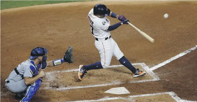  ?? BOB LEVEY/GETTY IMAGES ?? Jose Altuve and the Houston Astros scored early in Game 3 and held on for a 5-3 victory at Minute Maid Park on Friday to take a 2-1 lead in the World Series.