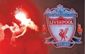  ??  ?? A Liverpool fan celebrate winning the Premier League outside Anfield, Liverpool, Britain, on June 25, 2020.
PHIL NOBLE/REUTERS