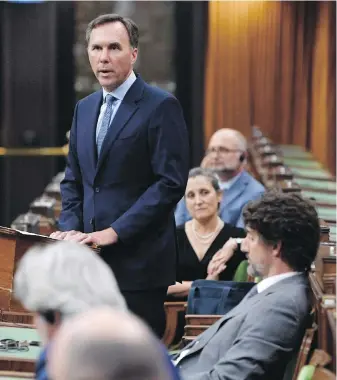  ??  ?? Minister of Finance Bill Morneau rises in the House of Commons on Wednesday to deliver the fiscal snapshot on economic recovery from the coronaviru­s pandemic.