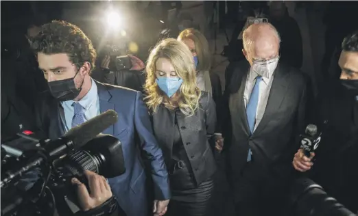  ?? NIC COURY/AP ?? Elizabeth Holmes (middle) leaves federal court with her partner, Billy Evans (left), after the verdicts Monday in San Jose, California.