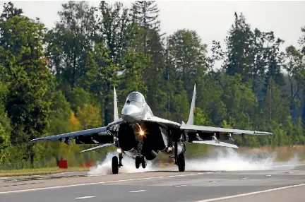  ?? PHOTO: REUTERS ?? A Belarusian MiG-29 military jet lands on the M4 road during military exercises near the village of Ratnaje, Belarus.