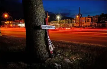  ?? Matt Rourke/Assocaited Press photos ?? This long exposure photo shows traffic driving on Roosevelt Boulevard on May 25 near a makeshift memorial for Samara Banks and three of her children, who were struck and killed by a car in 2013 in Philadelph­ia.