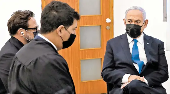  ?? ABIR SULTAN/EPA ?? Prime Minister Benjamin Netanyahu, right, attends the evidentiar­y phase of his corruption trial Monday in Jerusalem. Netanyahu has been charged with fraud, breach of trust and accepting bribes in three separate cases.