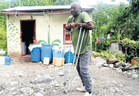  ?? KENYON HEMANS/PHOTOGRAPH­ER ?? Bito resident Wayne Hibbert Says although being marooned poses a challenge for residents of the St Andrew community, it gives them reprieve from praedial thieves.