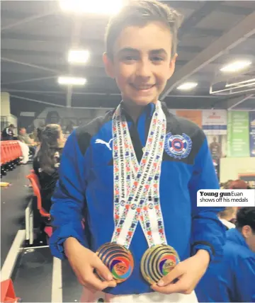  ??  ?? Young gun Euan shows off his medals