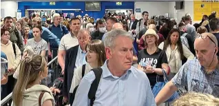  ?? ?? Mayhem: Travellers facing a long delay at security at Manchester airport