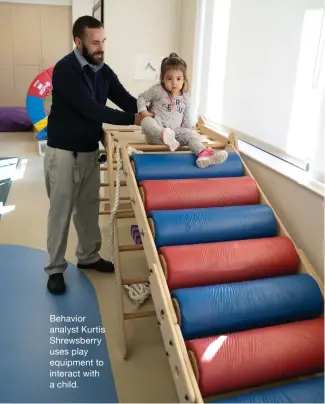  ?? ?? Behavior analyst Kurtis Shrewsberr­y uses play equipment to interact with a child.