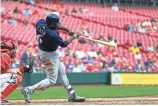  ?? AARON DOSTER/USA TODAY SPORTS ?? Milwaukee’s Lorenzo Cain hits the go-ahead home run against Cincinnati in the eleventh inning.