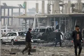  ?? RAHMAT GUL — THE ASSOCIATED PRESS ?? Afghan security personnel inspect the site of a bombing attack in Kabul on Sunday.