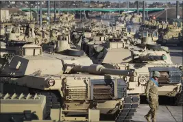 ?? CHRISTIAN MURDOCK — THE GAZETTE VIA AP, FILE ?? A soldier walks past a line of M1Abrams tanks at Fort Carson in Colorado Springs, Colo., on Nov. 29, 2016.
