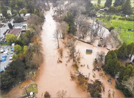  ?? Shmuel Thaler Santa Cruz Sentinel ?? THE SAN LORENZO RIVER, swollen by rain, f looded Santa Cruz earlier this month. Adapting to such new extremes is urgent.