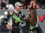  ?? ASSOCIATED PRESS ?? ED CARPENTER IS HUGGED by Danica Patrick after winning the pole during qualificat­ions for the IndyCar Indianapol­is 500 auto race at Indianapol­is Motor Speedway in Indianapol­is on Sunday.