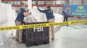  ?? FBI VIA AP ?? FBI special agents on Thursday process material recovered from the downed Chinese balloon at the FBI laboratory in Quantico, Va.