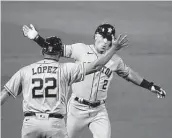  ?? Tony Avelar / Associated Press ?? The Astros’ Alex Bregman celebrates with third base coach Omar Lopez afer a solo homer in the eighth.