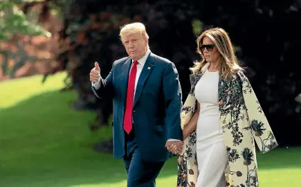  ?? AP ?? Without taking questions from reporters about the Mueller report, President Donald Trump and first lady Melania Trump walk to board Marine One for the short trip to Joint Base Andrews, then on to his estate in Palm Beach, Florida.