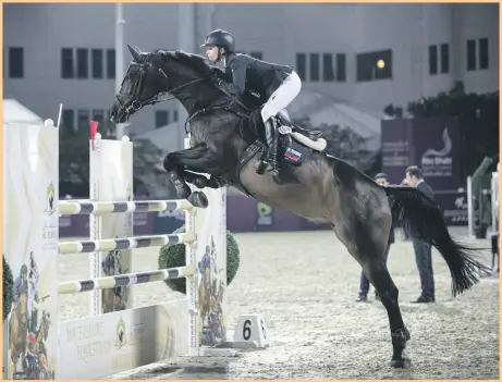 ?? Reem Mohammed / The National ?? Russian rider Anna Gorbacheva takes on a hurdle with Curt 13 last night on the final day of the FBMA Internatio­nal Show Jumping Cup, which took place at the Al Forsan Sports Resort in Abu Dhabi