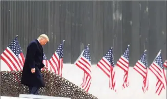  ?? Delcia Lopez / Associated Press ?? President Donald Trump walks down the steps before a speech near a section of the U.S.-Mexico border wall on Tuesday in Alamo, Texas.