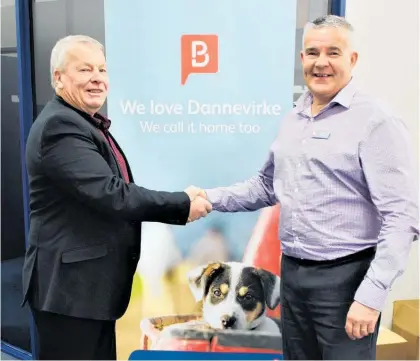  ??  ?? Outgoing Branch manager Kerry Sutherland (left) congratula­tes incoming Branch manager Dave Frith at Dannevirke Property Brokers.