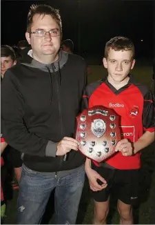  ??  ?? Dean Goodison of People Newspapers (sponsors) with Jack Anglim, captain of the Bannow-Ballymitty team.