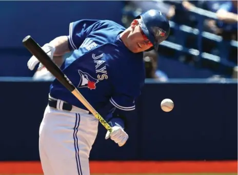  ?? STEVE RUSSELL/TORONTO STAR ?? The Jays’ Josh Donaldson gets hit by a pitch during Saturday afternoon’s 7-2 victory over the Houston Astros at a sunny Rogers Centre.