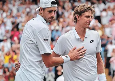  ?? GLYN KIRK THE ASSOCIATED PRESS ?? Kevin Anderson of South Africa, right, meets John Isner of the US on the court after defeating him in their men's singles semifinal match at the Wimbledon Tennis Championsh­ips, in London, on Friday.